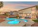 Inviting backyard features a sparkling pool, spa, and cozy seating area at 7078 Seabirds Pl, North Las Vegas, NV 89084