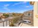 Balcony showcasing a view of a neighborhood with well-maintained homes under a beautiful blue sky at 7078 Seabirds Pl, North Las Vegas, NV 89084