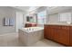 Bathroom featuring a large soaking tub, dual sinks and cabinets at 7078 Seabirds Pl, North Las Vegas, NV 89084