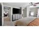 Bright bedroom with cozy bedding, a large dresser and a ceiling fan at 7078 Seabirds Pl, North Las Vegas, NV 89084