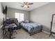 Bedroom featuring comfortable bed, ceiling fan and built in desk at 7078 Seabirds Pl, North Las Vegas, NV 89084