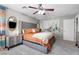 Bright primary bedroom with cozy bedding, two nightstands and a ceiling fan at 7078 Seabirds Pl, North Las Vegas, NV 89084