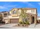 Inviting two-story home with a brown garage door, desert landscaping, and a charming entryway at 7078 Seabirds Pl, North Las Vegas, NV 89084