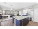 Open concept kitchen with island seating, stainless steel appliances, and views to the living room at 7078 Seabirds Pl, North Las Vegas, NV 89084