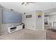 Cozy living room with large tv, modern furniture and comfortable carpeting throughout at 7078 Seabirds Pl, North Las Vegas, NV 89084