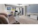 Living area featuring a comfortable sofa, large television, and built-in speakers for immersive entertainment at 7078 Seabirds Pl, North Las Vegas, NV 89084
