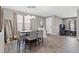 Open living space with wood-look floors, a dining area, and a workstation at 7078 Seabirds Pl, North Las Vegas, NV 89084