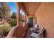 Inviting balcony with outdoor furniture and serene garden view at 730 Hardy Way # A, Mesquite, NV 89027