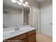 Bathroom with white sink and wood vanity. Mirror reflects a white tub/shower combination and white toilet at 730 Hardy Way # A, Mesquite, NV 89027
