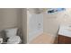 Bathroom with a white toilet, tub, and sink with neutral paint and tile, creating a simple and clean space at 730 Hardy Way # A, Mesquite, NV 89027