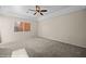 Open bedroom features a tray ceiling, carpet, and window at 730 Hardy Way # A, Mesquite, NV 89027