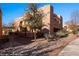 An exterior shot of a multi-story southwestern style home with mature desert landscaping at 730 Hardy Way # A, Mesquite, NV 89027