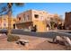 Exterior shot of a beautiful multi-story southwestern style home with garages and desert landscaping at 730 Hardy Way # A, Mesquite, NV 89027