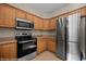 Spacious kitchen features stainless steel appliances, including a stove, microwave, and light wood cabinetry at 730 Hardy Way # A, Mesquite, NV 89027