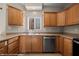 Kitchen featuring stainless steel appliances, wood cabinetry, and ample counter space with a window to let in light at 730 Hardy Way # A, Mesquite, NV 89027