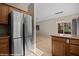 Bright kitchen with stainless steel refrigerator and view of living room with natural light shining through a sliding glass door at 730 Hardy Way # A, Mesquite, NV 89027