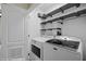 Laundry room with newer white Maytag washer and dryer units and modern gray shelving at 730 Hardy Way # A, Mesquite, NV 89027