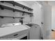 Laundry room with newer white Maytag washer and dryer units and modern gray shelving at 730 Hardy Way # A, Mesquite, NV 89027