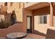 Exterior shot of a patio with a round mosaic table and doorway to a beautiful Southwestern-style home at 730 Hardy Way # A, Mesquite, NV 89027