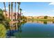 The beautiful landscaping of the community with a serene pond reflecting palm trees and the building at 730 Hardy Way # A, Mesquite, NV 89027