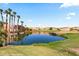 The community landscape with a pond overlooking a golf course with palm trees at 730 Hardy Way # A, Mesquite, NV 89027