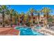A tranquil community pool and jacuzzi surrounded by palm trees and lounge chairs at 730 Hardy Way # A, Mesquite, NV 89027