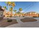 Expansive backyard featuring a private pool, lush palm trees, and desert landscaping at 7338 Flying Pegasus Ct, Las Vegas, NV 89131