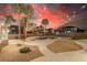 Stunning backyard with a pool, spa, palm trees, and outdoor lighting, perfect for entertaining at 7338 Flying Pegasus Ct, Las Vegas, NV 89131