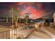 Wide balcony overlooking a backyard featuring a pool, spa, palm trees, and outdoor lighting at 7338 Flying Pegasus Ct, Las Vegas, NV 89131
