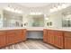 A luxurious Primary bathroom featuring dual sinks, a vanity area, and wood look tile floors at 7338 Flying Pegasus Ct, Las Vegas, NV 89131