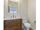 Half bathroom with granite vanity, ornate mirror and modern fixtures at 7338 Flying Pegasus Ct, Las Vegas, NV 89131