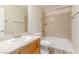 Bright bathroom featuring a single sink vanity with light wood cabinets and a shower-tub combo at 7338 Flying Pegasus Ct, Las Vegas, NV 89131