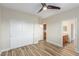 Bright bedroom featuring wood-look floors and access to closet, bath and additional rooms at 7338 Flying Pegasus Ct, Las Vegas, NV 89131