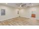 Neutral bedroom featuring wood-look flooring, bright natural light, and a modern ceiling fan at 7338 Flying Pegasus Ct, Las Vegas, NV 89131