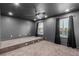 Bedroom with modern design elements including dark walls, neutral carpet, and a ceiling fan at 7338 Flying Pegasus Ct, Las Vegas, NV 89131