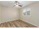 Cozy bedroom featuring wood-look floors, neutral walls, and a window with white blinds at 7338 Flying Pegasus Ct, Las Vegas, NV 89131