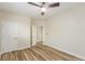 Light-filled bedroom with wood-look flooring, neutral walls, and a doorway leading to another room at 7338 Flying Pegasus Ct, Las Vegas, NV 89131