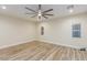 Neutral bedroom featuring wood-look flooring, bright natural light, and a modern ceiling fan at 7338 Flying Pegasus Ct, Las Vegas, NV 89131