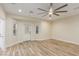Versatile bonus room featuring wood-look floors, neutral walls, and a door to the backyard at 7338 Flying Pegasus Ct, Las Vegas, NV 89131