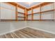 Spacious walk-in closet features custom wood shelving for ample storage at 7338 Flying Pegasus Ct, Las Vegas, NV 89131