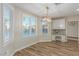 Bright dining area featuring wood-like floors, white cabinets, granite countertops and modern lighting at 7338 Flying Pegasus Ct, Las Vegas, NV 89131