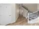 Stairway with hardwood flooring, and white railing with black wrought iron at 7338 Flying Pegasus Ct, Las Vegas, NV 89131