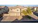 Beautiful two-story home with a three car garage and a well-manicured front yard at 7338 Flying Pegasus Ct, Las Vegas, NV 89131