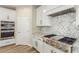 A chef-inspired kitchen with stainless steel appliances, custom cabinetry, and stone countertops at 7338 Flying Pegasus Ct, Las Vegas, NV 89131