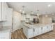 Spacious kitchen featuring a large center island, stainless steel appliances, and elegant pendant lighting at 7338 Flying Pegasus Ct, Las Vegas, NV 89131