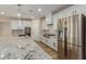 Bright kitchen showcases stainless appliances, generous island, and stylish countertops, perfect for culinary enthusiasts at 7338 Flying Pegasus Ct, Las Vegas, NV 89131