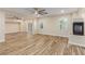 Spacious living room featuring tile flooring, a fireplace, large windows and ceiling fans at 7338 Flying Pegasus Ct, Las Vegas, NV 89131