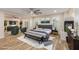 Large staged bedroom with a ceiling fan and sitting area at 7338 Flying Pegasus Ct, Las Vegas, NV 89131