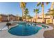 Backyard pool with a spa, a basketball hoop, and some beautiful palm trees at 7338 Flying Pegasus Ct, Las Vegas, NV 89131