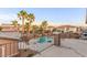 Balcony with a view of the pool, palm trees, and neighboring houses at 7338 Flying Pegasus Ct, Las Vegas, NV 89131